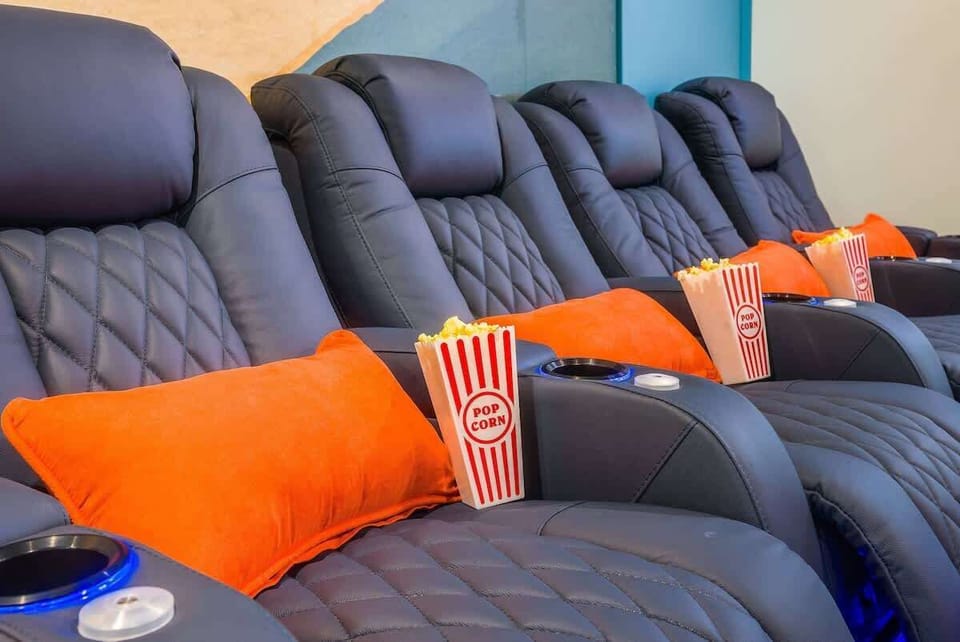 Reclining theater seats w/ soft pillows ready for a cozy film night