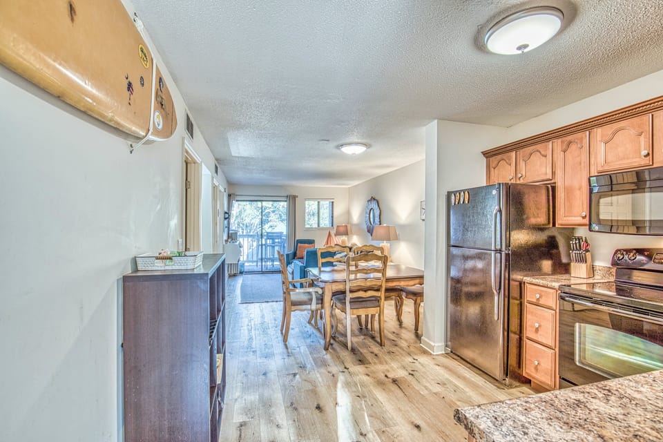 Sunny open kitchen equipped with modern appliances and textured countertops
