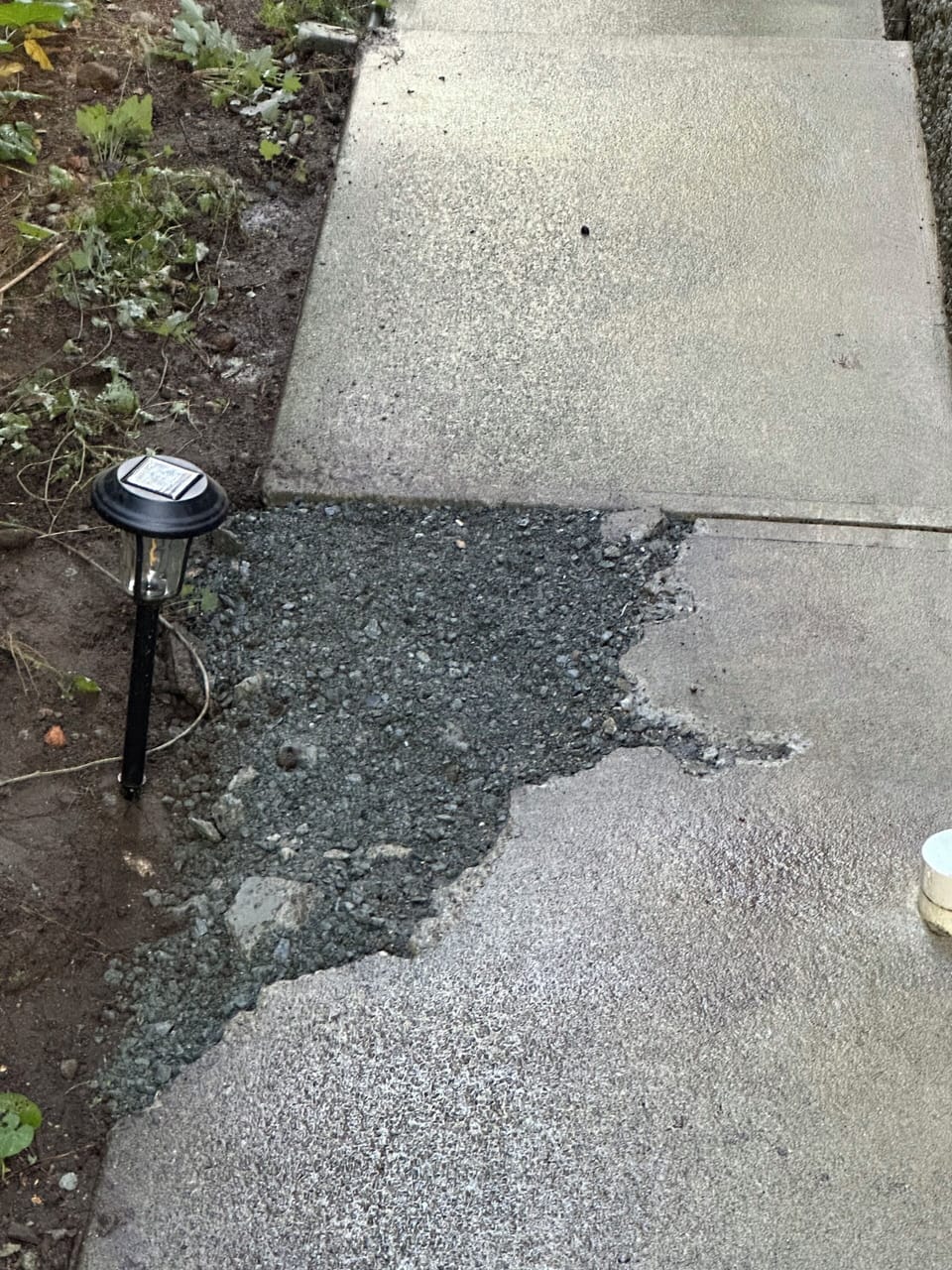 Current walkway: concrete removed for drainage work. Entrance remains accessible