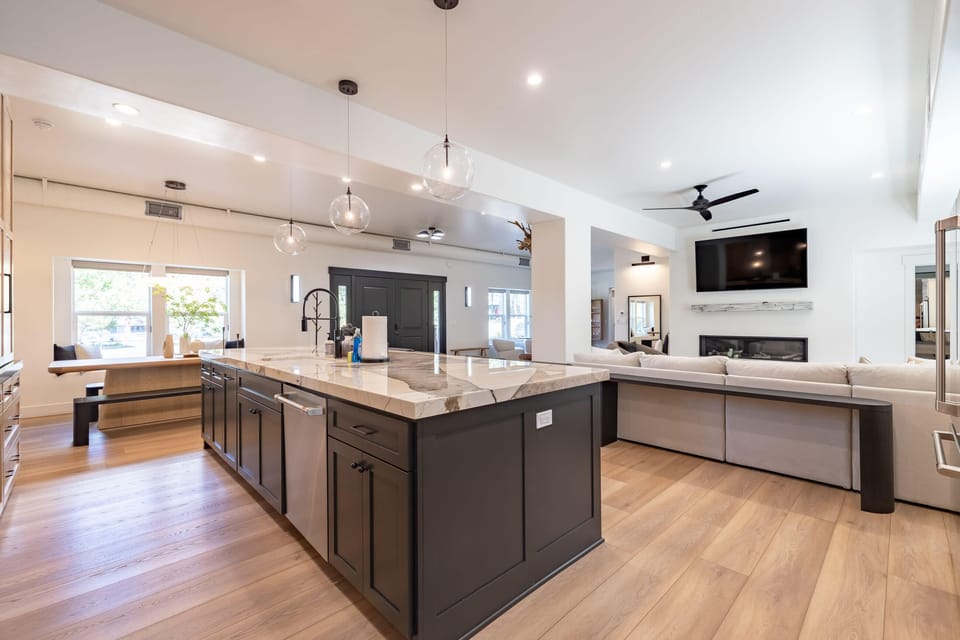 Open concept living area with gas fireplace, smart TV, and chef's kitchen
