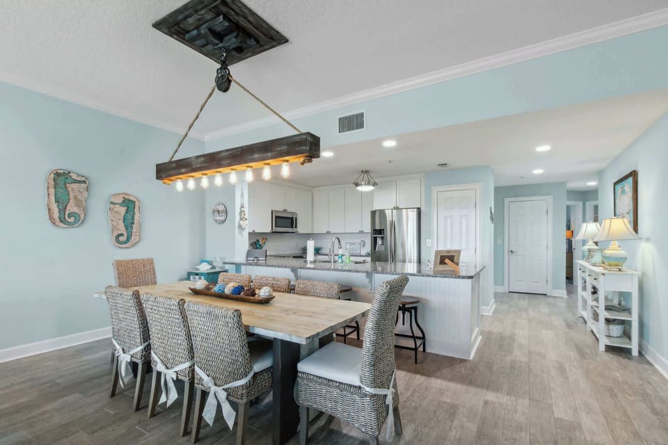 Dining room table seats 8, entrance/exit from unit through hallway. Pantry door next to fridge