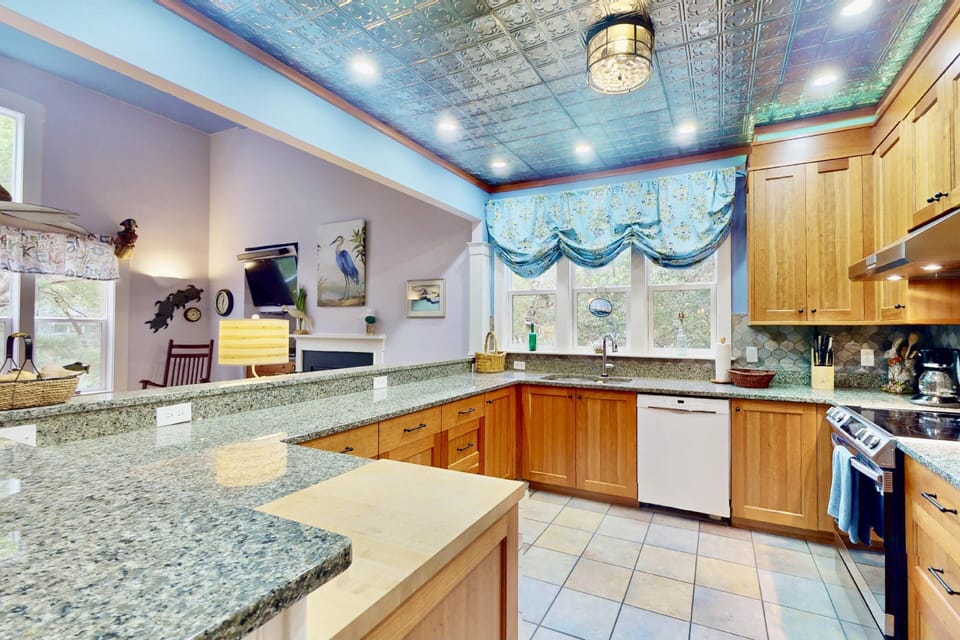 The kitchen features a custom tin ceiling and an abundance of counter space