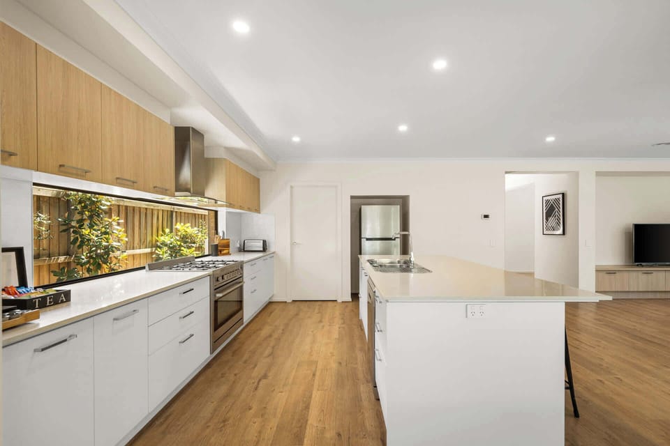 Expansive kitchen with modern appliances and breakfast bar