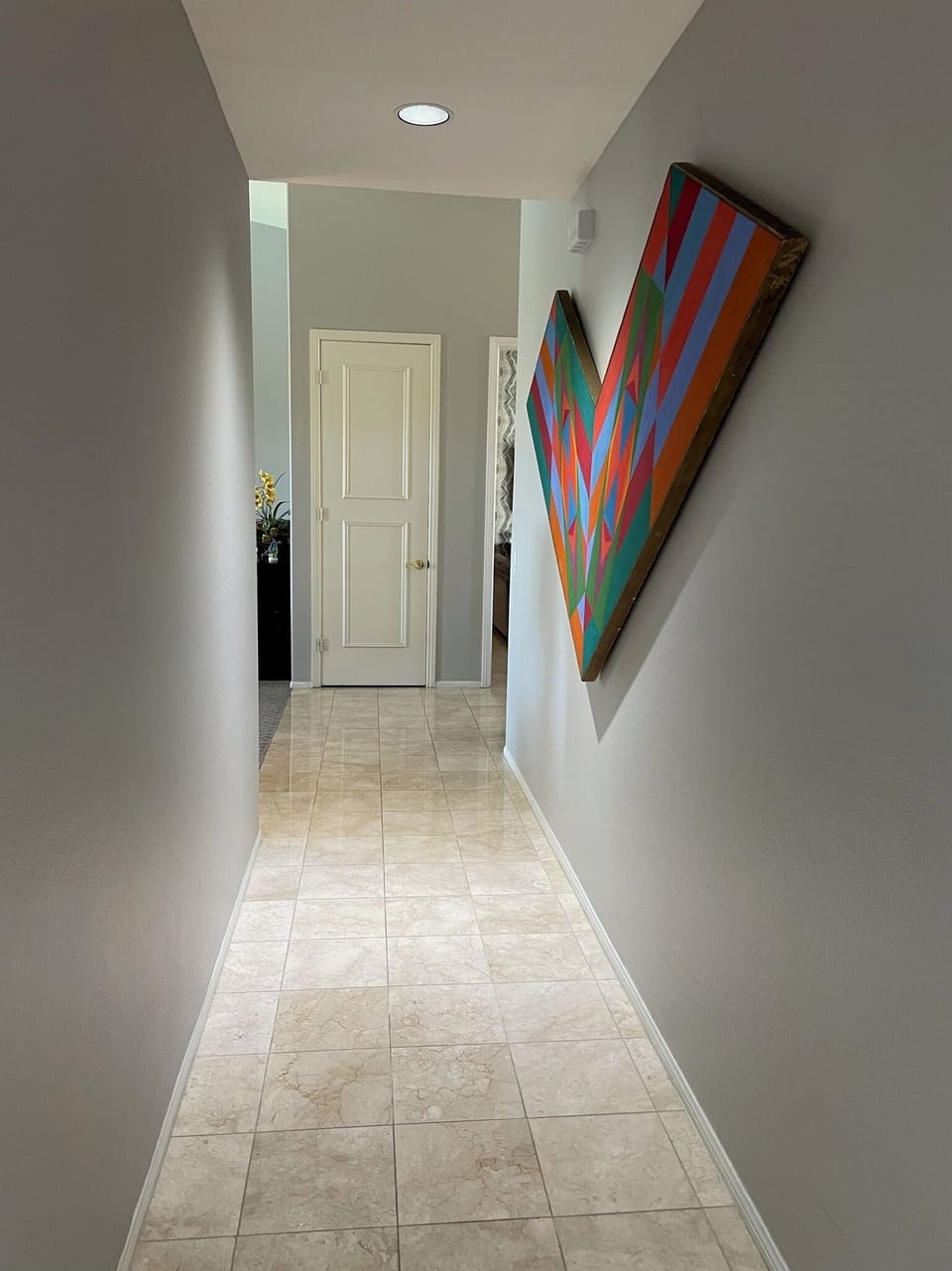 Hallway to the bedrooms and powder room at end of hall prior to bedrooms