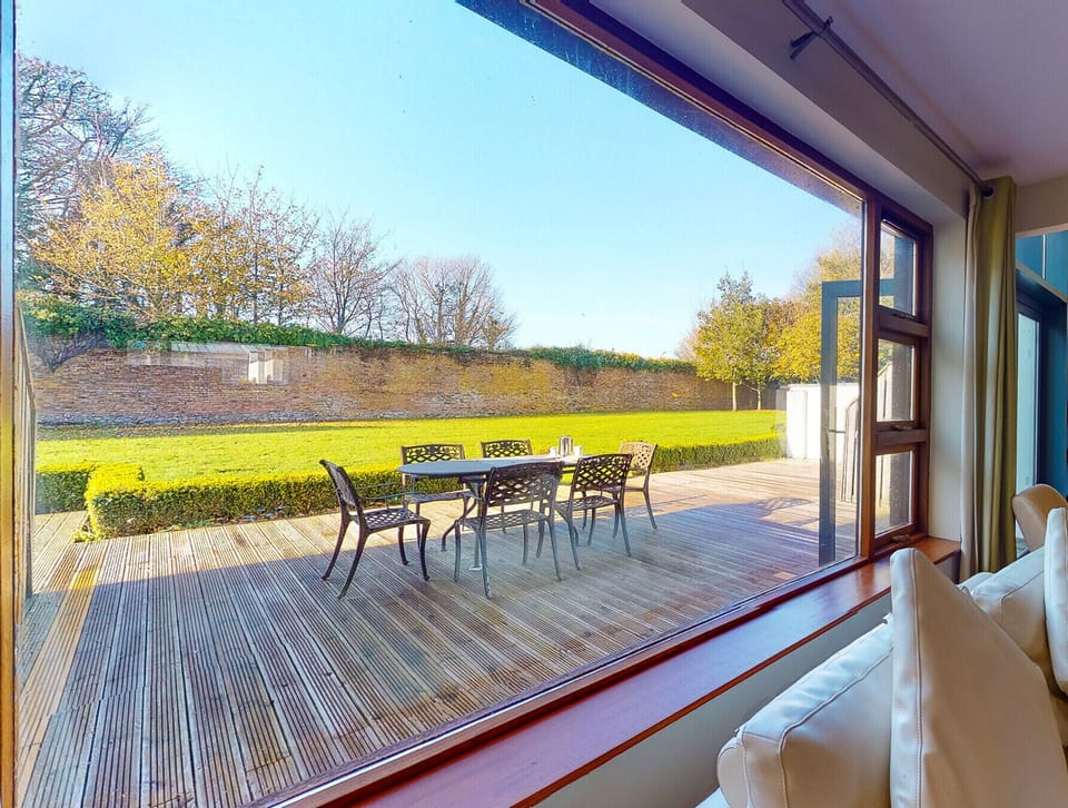Castlemartyr Holiday Lodges, East Cork, County Cork, Ireland. Pet friendly holiday home. Patio, deck with dining furniture. Views to the garden. Open plan.