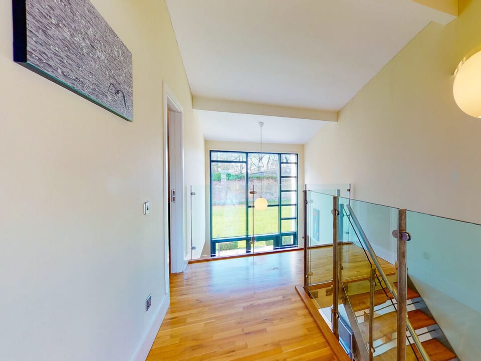 Castlemartyr Holiday Lodges, East Cork, County Cork, Ireland. Pet friendly holiday accommodation. Stylish wooden staircase, glass, views to the garden. Contemporary modern decor.