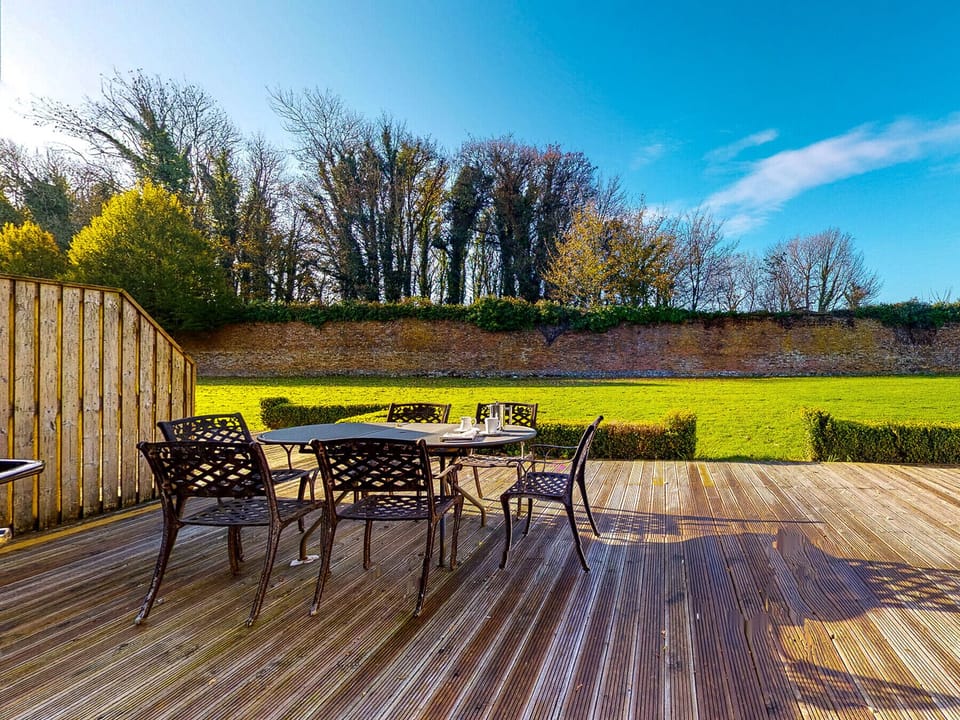 Castlemartyr Holiday Lodges, East Cork, County Cork, Ireland. Pet friendly holiday home. Patio, deck with dining furniture. Views to the garden. Open plan.