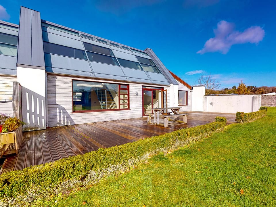 Castlemartyr Holiday Lodges, East Cork, County Cork, Ireland. Pet friendly holiday home. Patio, deck with dining furniture. Views to the garden. Open plan.
