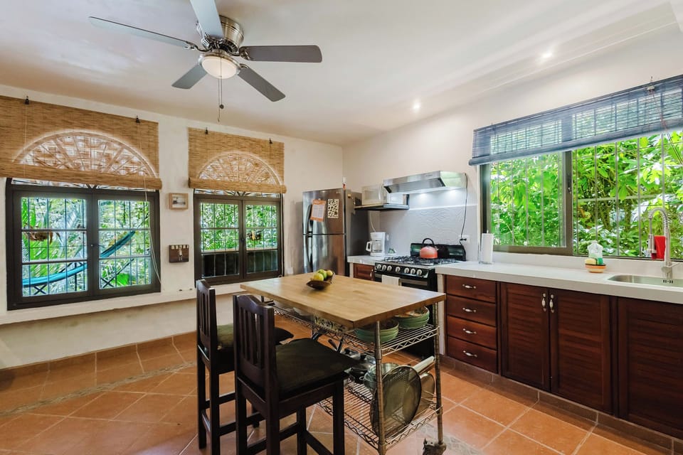 Bright garden-view kitchen with island seating and spacious counters