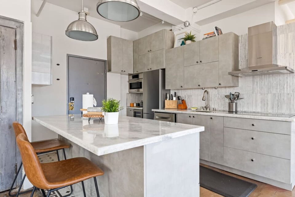 Contemporary kitchen with full amenities, from sleek cabinetry to stainless steel appliances. Everything you need for home-cooked meals.