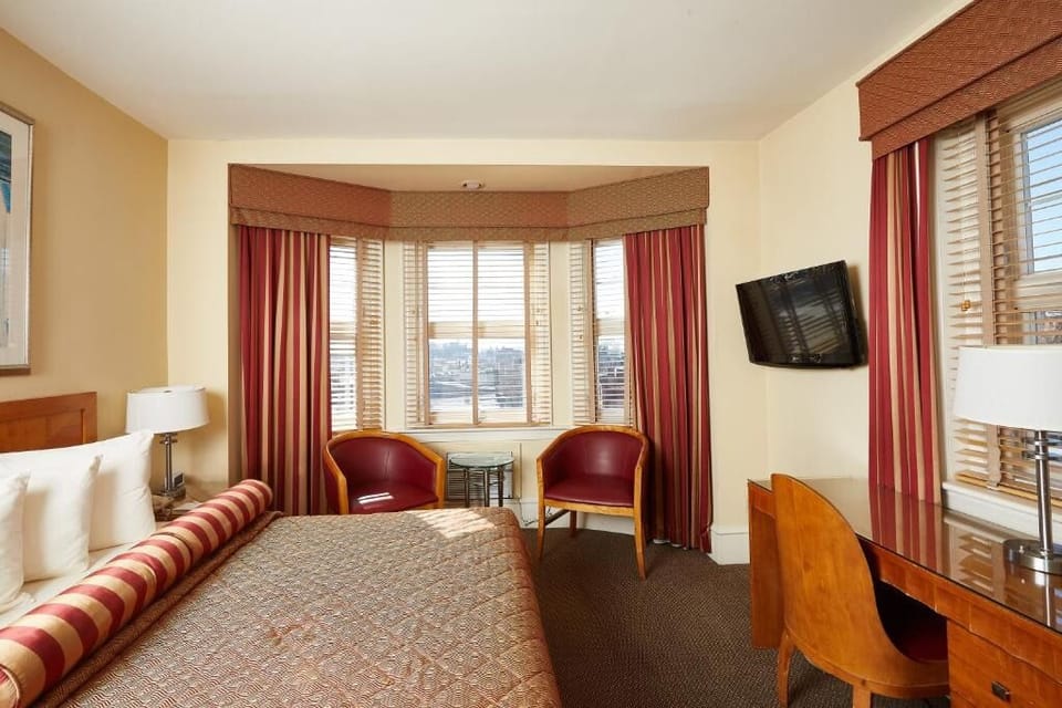 Relax in a sunlit room with bay-window city views.