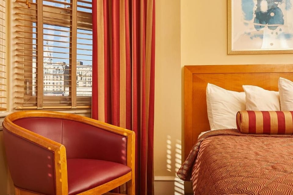 Unwind in a sunlit room with cozy city-view charm.