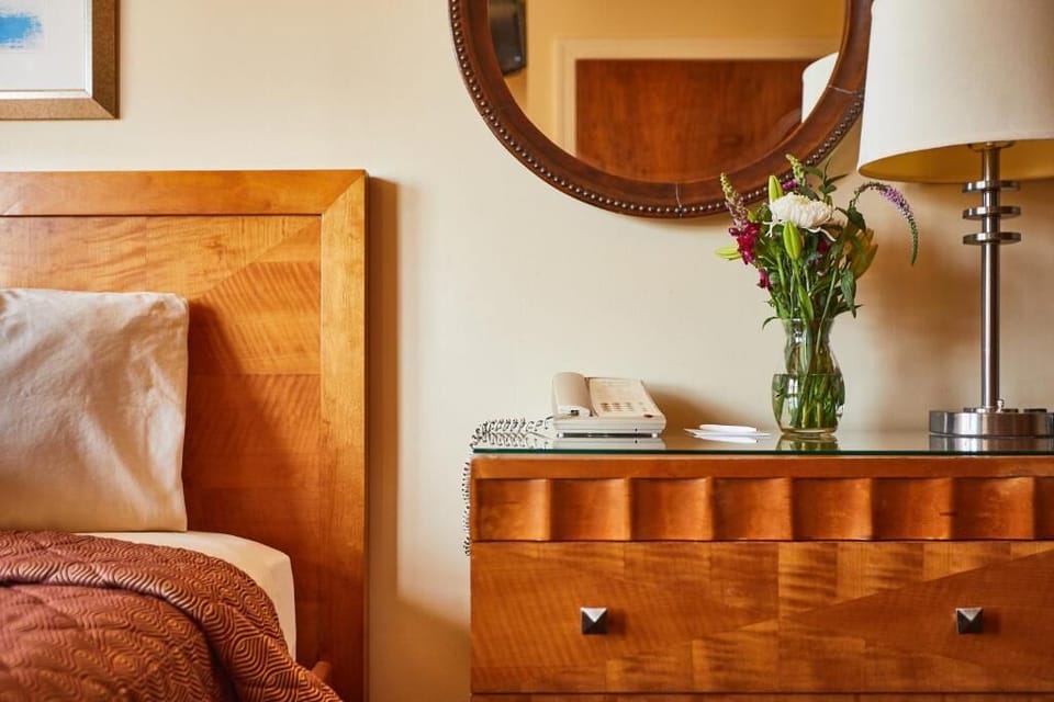 Settle in with elegant bedside details and warm, restful tones.
