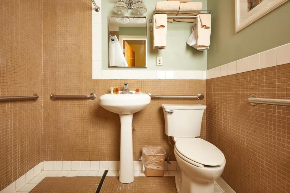 Refresh easily in a spacious bath with helpful grab bars.