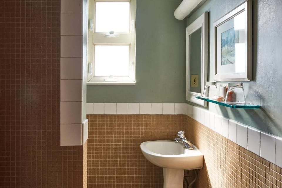 Freshen up in a bright, tiled bath with clean lines.