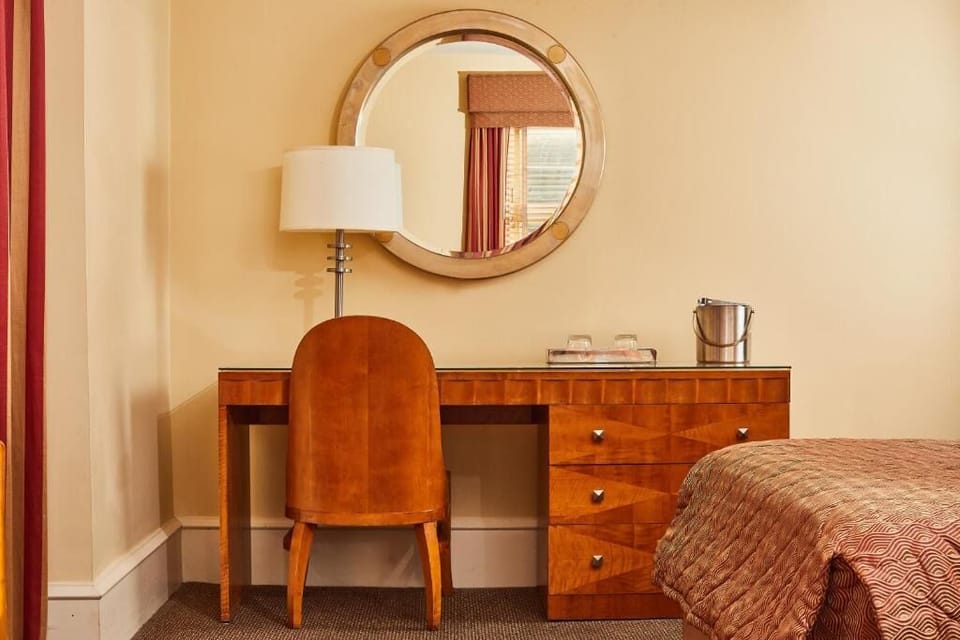 Plan the day at a sleek desk with mirror and lamp.