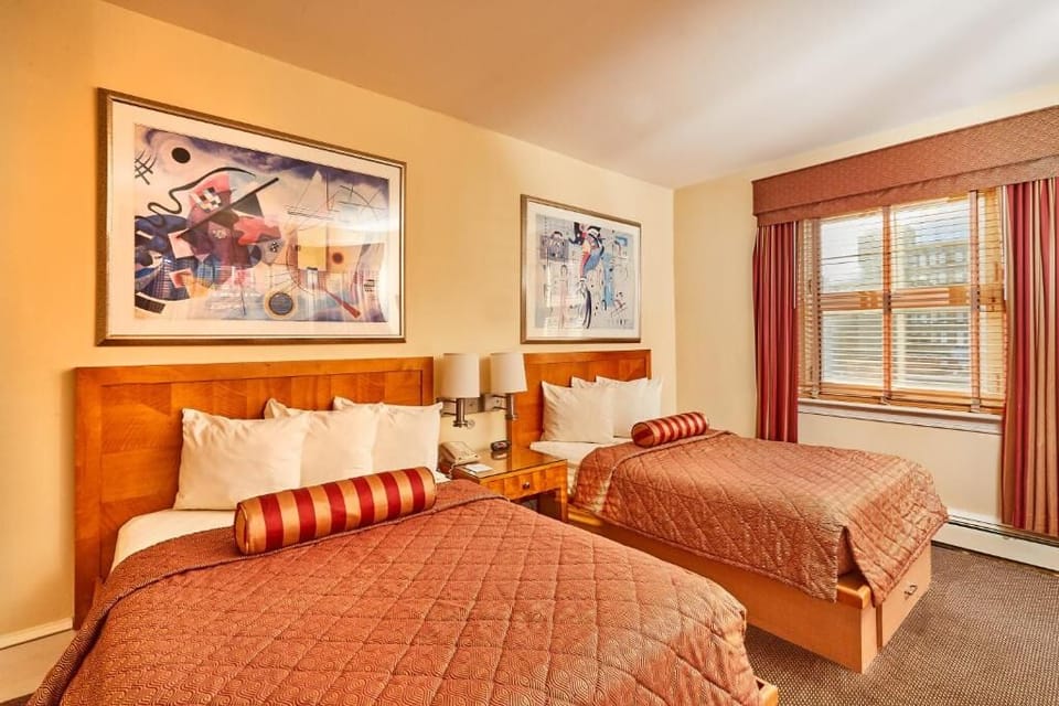 Sink into crisp linens beneath stylish artwork and warm lighting.
