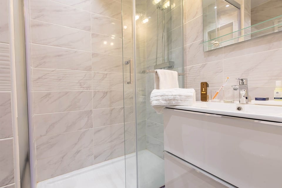 The spacious and modern bathroom features stylish décor.