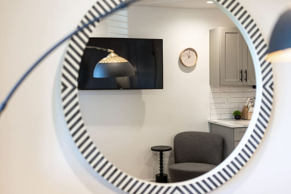 Cozy living room with a Smart TV, room-darkening shades, and pull-out couch just off the kitchen space.