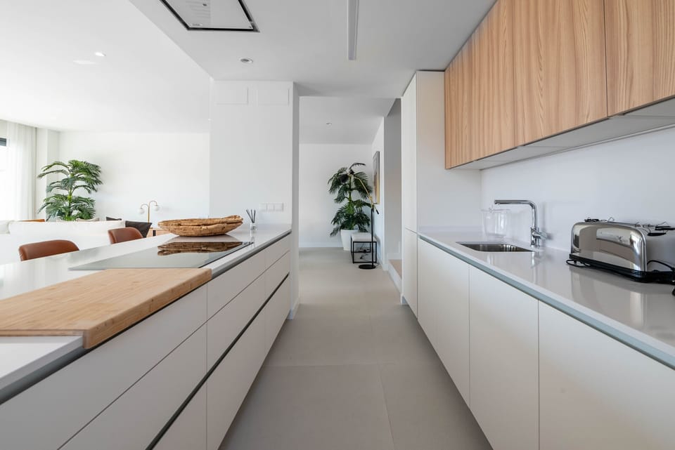 Kitchen open to the living-dining room and views to the terrace with private swimming pool to enjoy your holidays.