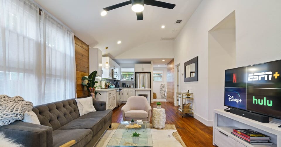 Step into a spacious living area where the kitchen, dining, and lounge spaces flow seamlessly together