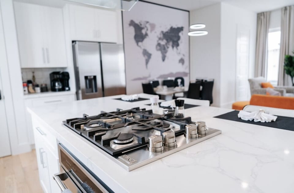 Chef-inspired kitchen with white marble countertops, modern finishes, and ample prep space for effortless cooking