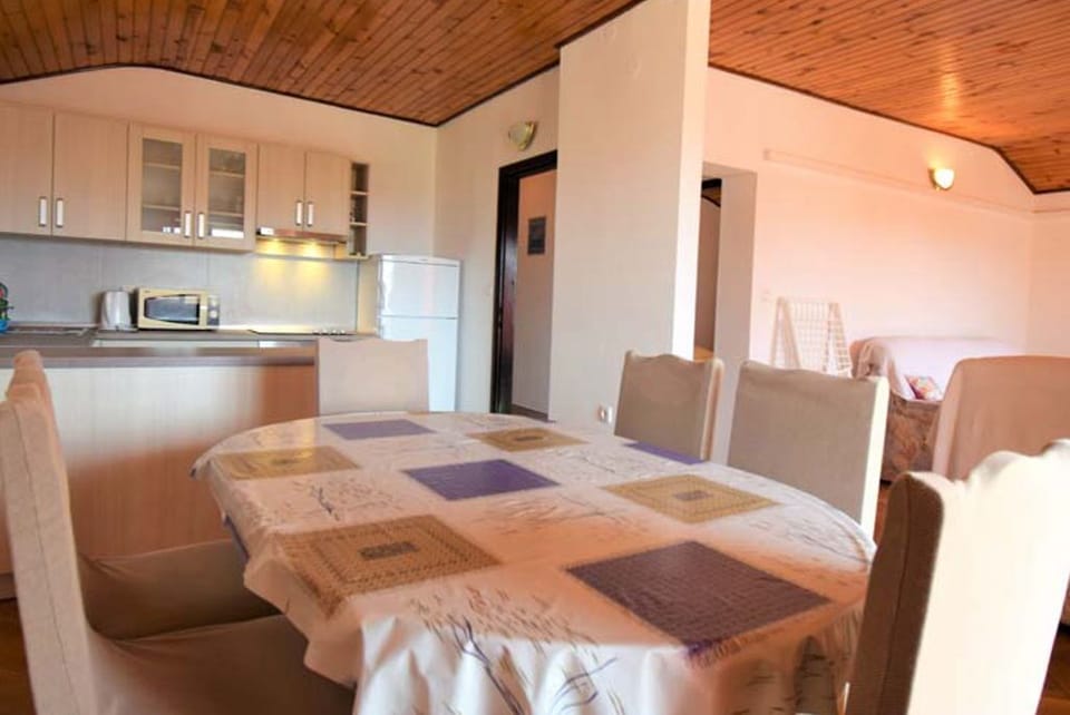 Dining and living area with natural light.