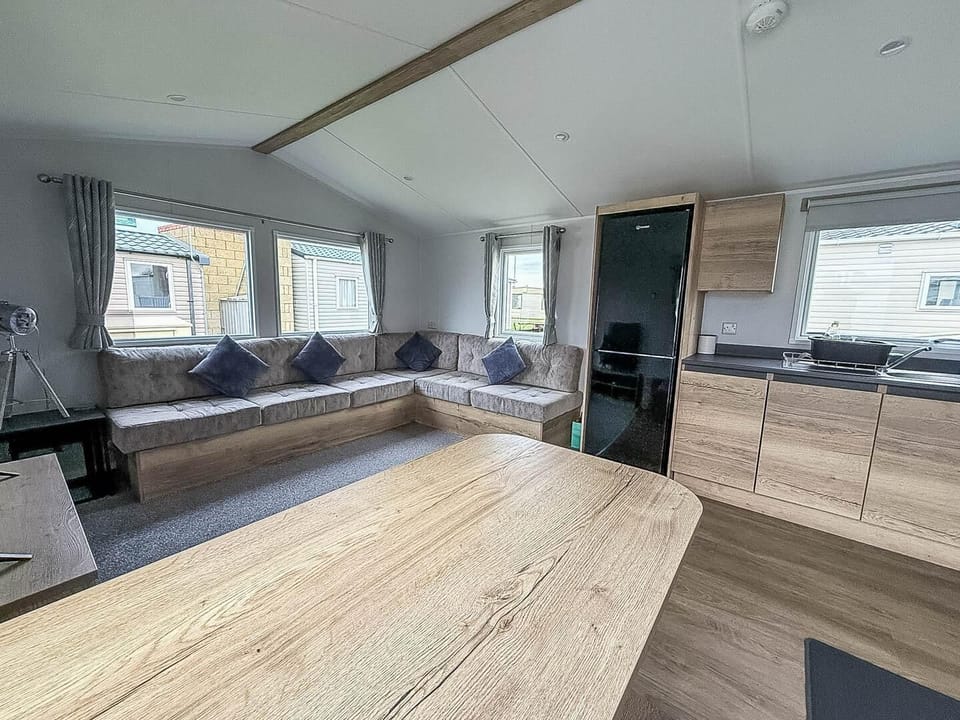 Bright and cozy living area with panoramic windows and modern kitchen