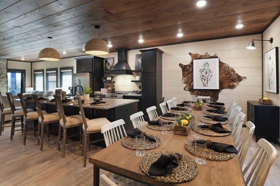 Spacious rustic dining area with seating for twelve and a modern kitchen island.