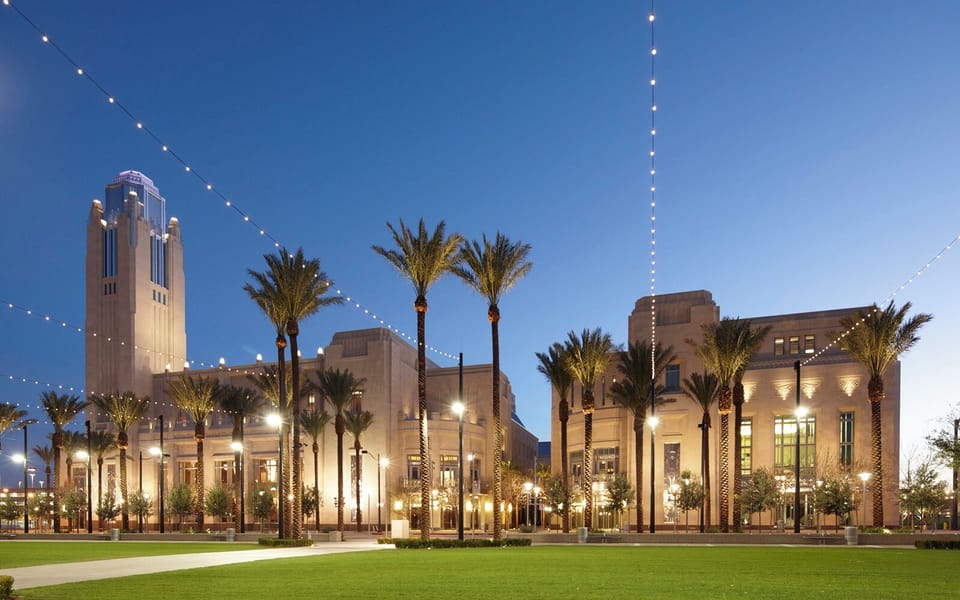 Arrive at a glowing resort promenade under twinkling lights.