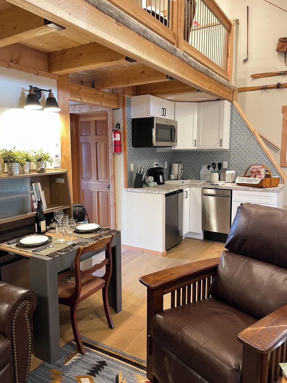 Saw marked wood floors downstairs with cozy area rugs.