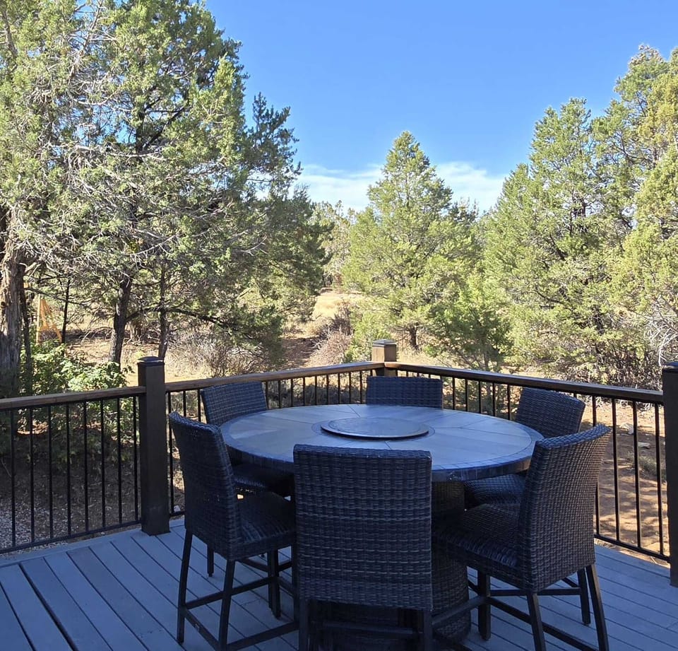 Secluded outdoor dining area with grill.