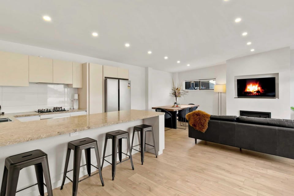 Sleek and stylish, this modern kitchen flows seamlessly into the open-plan living and dining area.
