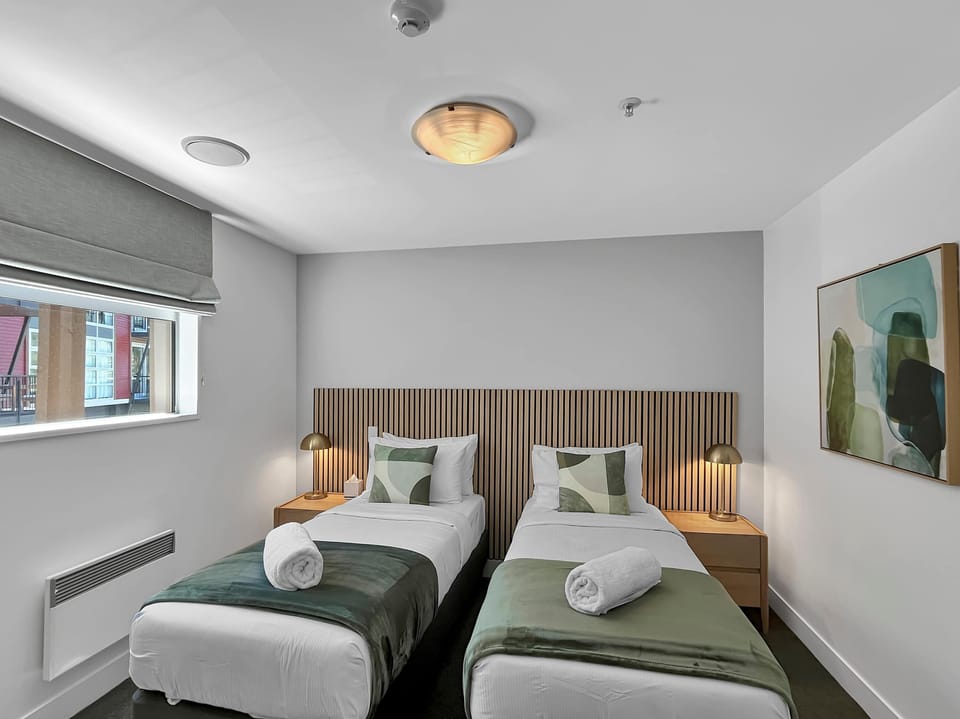 Twin bedroom designed for comfort, complete with plush bedding.