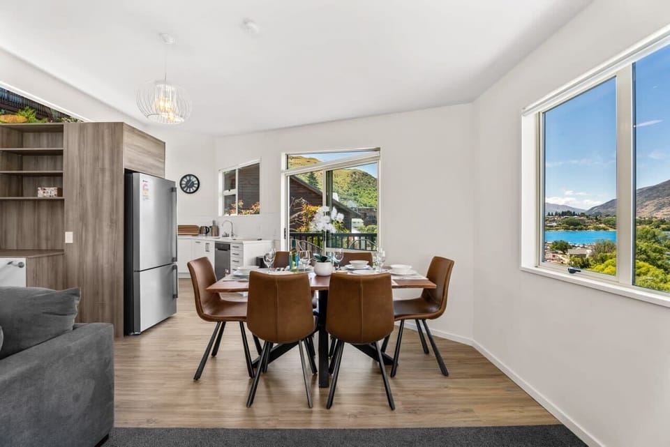 Spacious open-plan kitchen and dining area with a large table seating six
