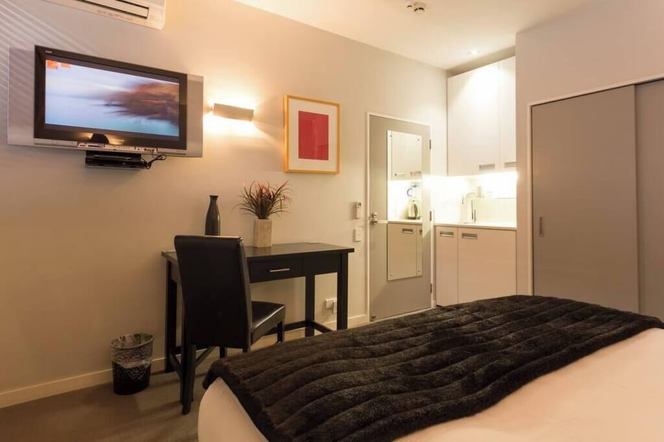 Bedroom with desk and kitchenette