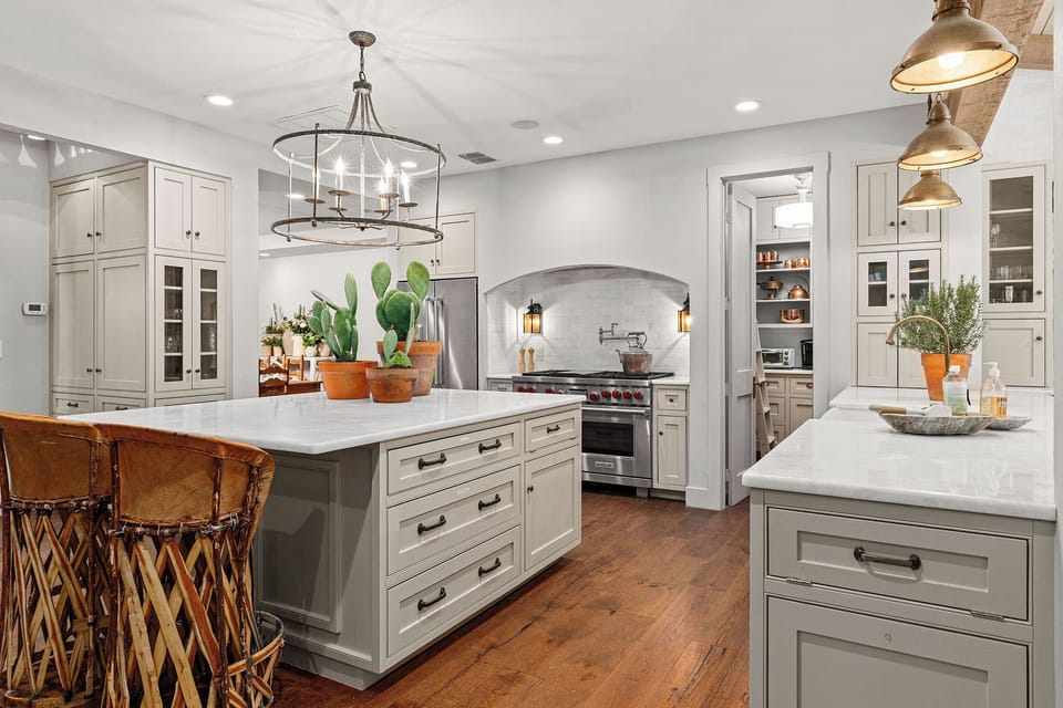 This spacious chef's kitchen is designed for cooking up feasts for family and friends. With high-end appliances, ample counter space, and everything you need to create memorable meals, it's the perfect hub for gathering and sharing great company.