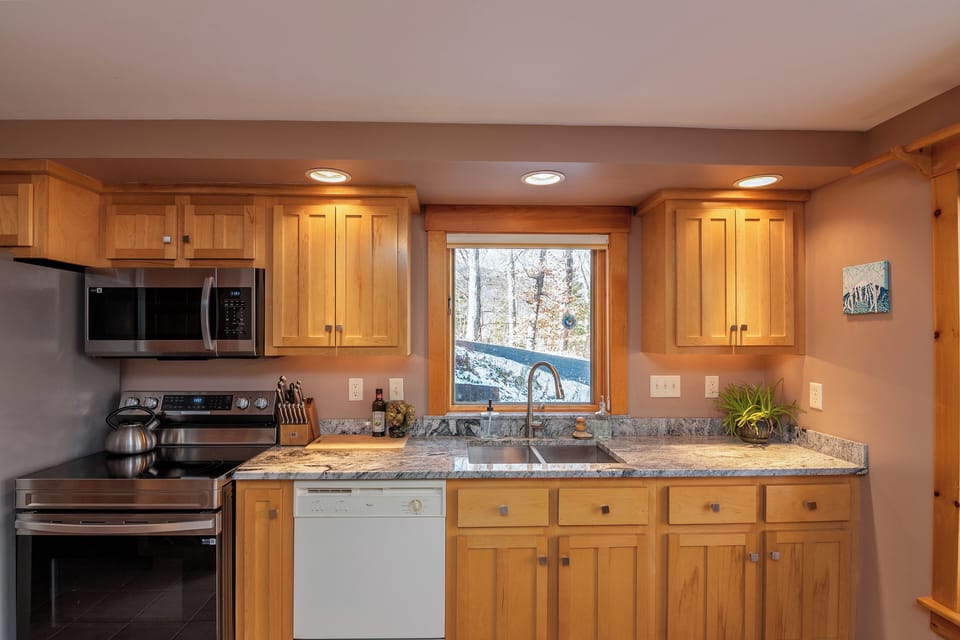 Kitchen with dishwasher/ full size range/ microwave and fridge with ice maker.