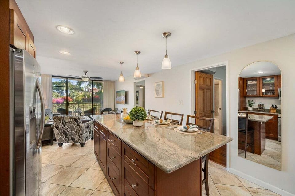 Bright dining space with large window, table set for four, and tiled flooring.