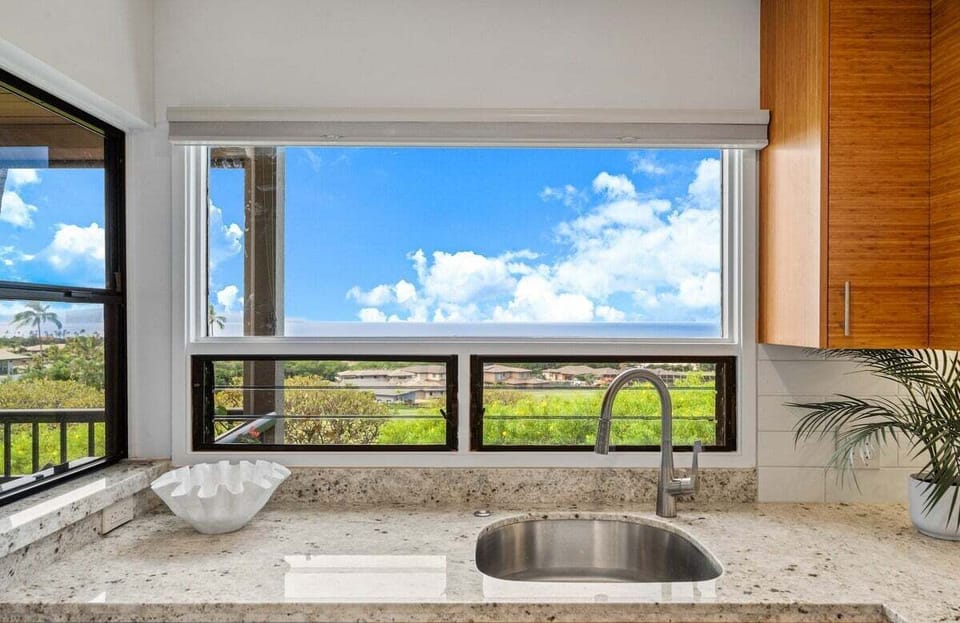 Sinks frame with granite and glass, skies and greenery flowing into the view.