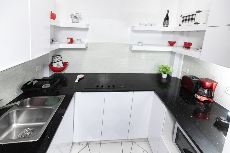 The kitchen is equipped with a stovetop and oven, allowing you to prepare a variety of meals
