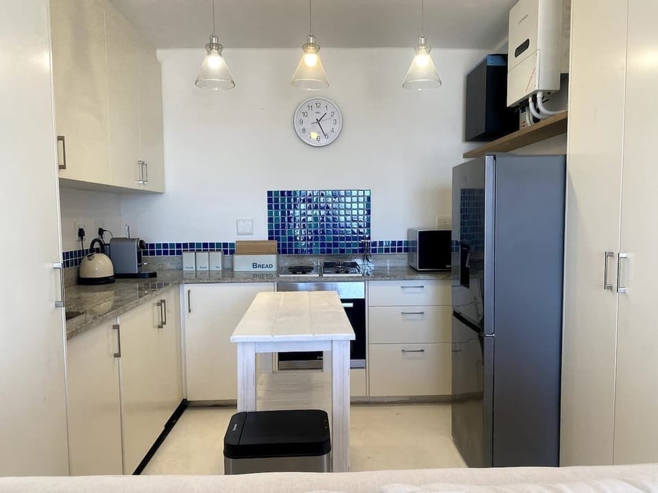 A fully equipped kitchen with washer/dryer, oven, stove top with gas and electric, fridge/freezer combo, an additional bar fridge and the usual microwave, toaster, kettle and Nespresso machine.