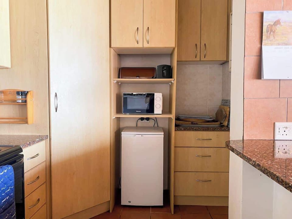 There is a bar fridge for the drinks but there is also a large fridge/freezer on the other end of the kitchen for everything else.