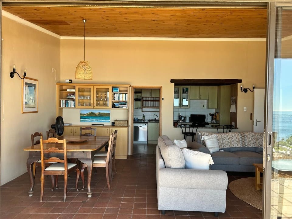 The open plan living is ideal for the hub of the house! Step through the doors onto the patio that leads down to the rocks and the beach just a couple meters to the right.