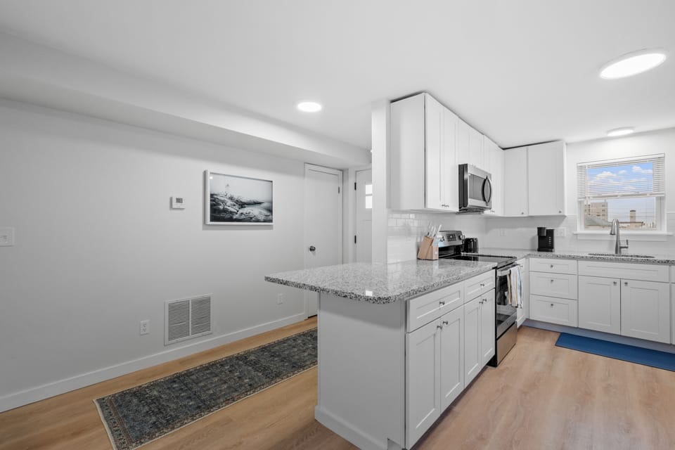 Plenty of counter space! Kitchen is stocked with cookware and utensils.