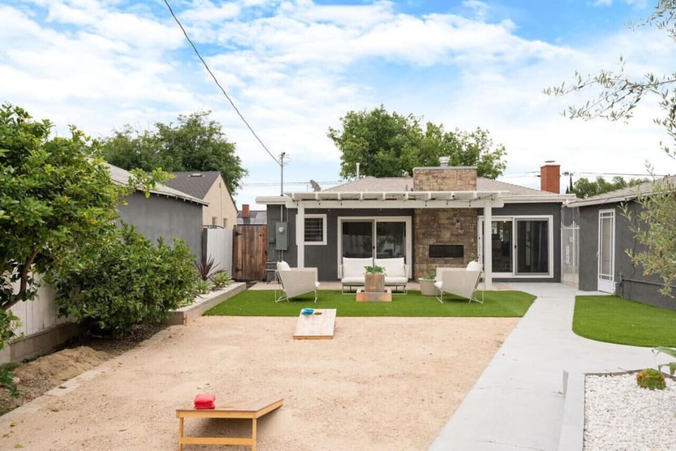 Take in the stunning backyard view of the house, where the spacious outdoor area seamlessly blends with the home`s inviting design, offering a perfect retreat for relaxation and enjoyment.