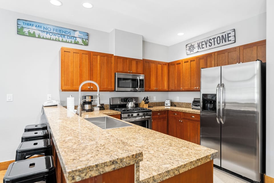 Cook up your mountain adventures in this spacious kitchen featuring granite counters, stainless appliances, and all the tools you need.