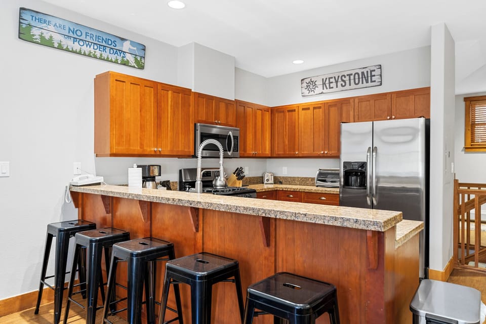 Your fully equipped kitchen with granite counters and breakfast bar creates the perfect spot for cooking meals and gathering together.