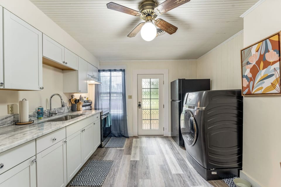 Modern kitchen with a full fridge and LG ventless washer/dryer combo.
