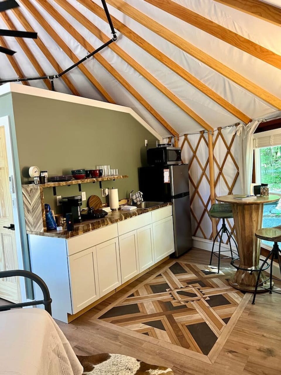 Step outside to your private outdoor oasis featuring a cozy deck, grill, and shaded seating area. Relax by the fire pit with free firewood provided. This peaceful retreat offers the perfect blend of comfort and adventure.